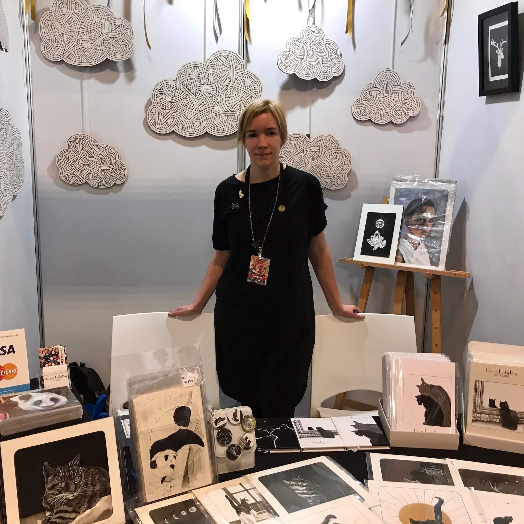Artist surrounded by artworks at ComicCon Johannesburg